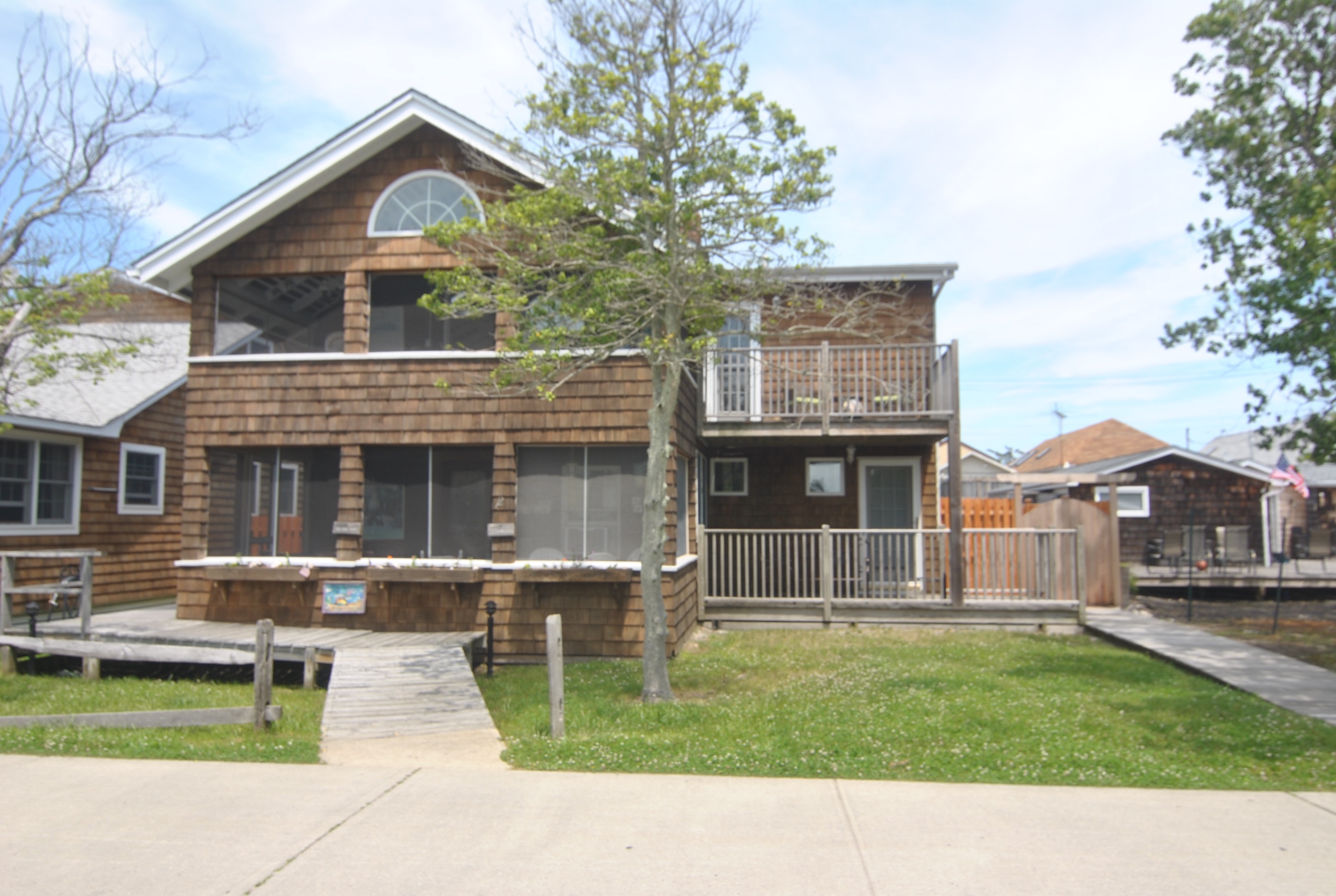 Lovely renovated home.  If you're looking for a place with great outdoor space, look no further.  This home has an enormous rear deck.  Granite kitchen. 4 bedrooms, 3 bathrooms.  Fireplace. Screened in dining porch. Convenient to town.  