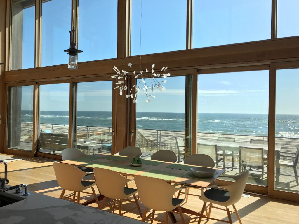 This modernist oceanfront beach house, designed by noted architect Eric Schiller, sits atop the crest of the dune on a high point of the Island, with spectacular views from every room. Located in the tranquil Dunewood community, this very special property is the retreat you've been waiting for.  Constructed in 2015, the home features massive floor to ceiling glass, double-height living room and dining room, and an open floor plan to maximize flow. The expansiveness of the spaces blends the interior with the great outdoors. There are 3 comfortable bedrooms, with room to create a 4th, and 2½ baths. Watch the sunrises and sunsets from the upstairs den, which has panoramic views of both the ocean and the bay. <BR>
<BR>
The highest quality materials were used throughout the home, including clear red cedar interiors, hurricane rated windows, and yellow Alaskan cedar siding. The chef’s kitchen boasts hand-selected Calacatta marble counters, top-shelf appliances including a SubZero refrigerator, Gaggenau induction cooktop, oven, and  microwave drawer, and Miele dishwasher, and Vola faucet and sink spray. The Moreso wood burning stove in the main space sits atop a Pietra Cardosa hearth, and will keep you cozy when temperatures dip. The home is also equipped with central air conditioning and heating for your comfort. The Carrera marble bathrooms are luxuriously outfitted with Vola faucets and shower systems, custom sinks and Toto toilets, or you can head outside to utilize the large outdoor shower. Thoughtfully designed integrated storage spaces offer plenty of room to store your belongings.  The deck in the front of the house can be fully shaded by the retractable custom Markilux motorized awnings. This exquisite home is one of a kind and is not to be missed!