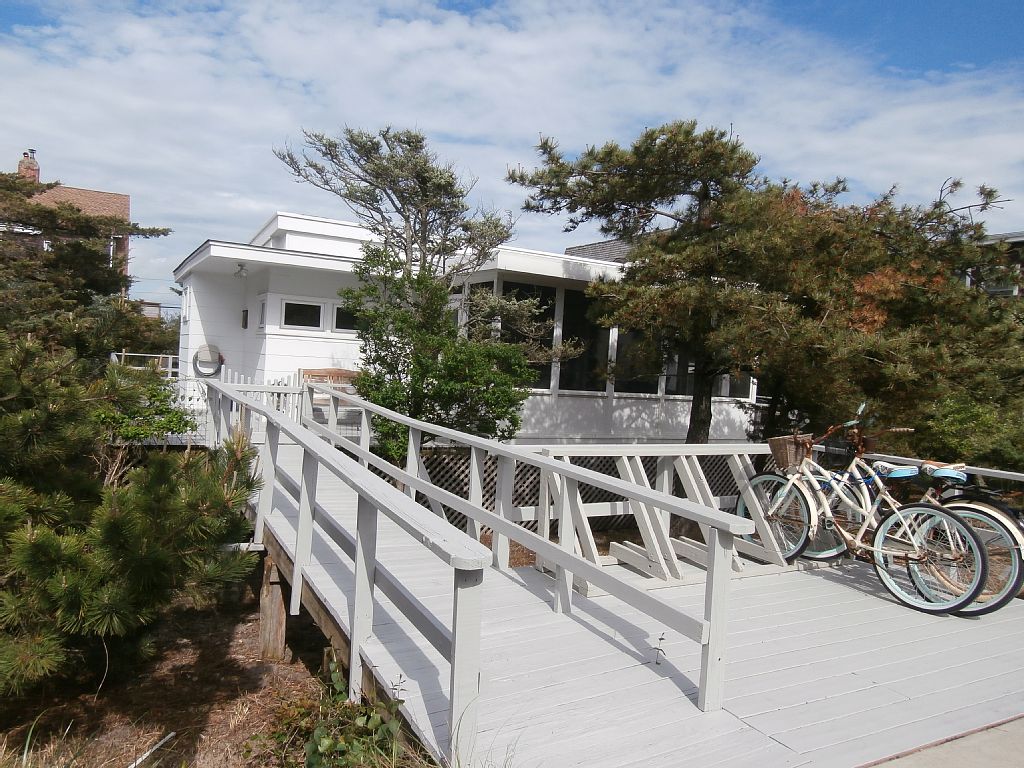 Rare opportunity to own a home just one back from the beach on a great Seaview block.  This bright and airy mid century ranch has 3 bedrooms, 1.5 baths, a charming screened in porch and wraparound deck.  Enjoy this classic home, or build your dream house with stunning Atlantic Ocean views.  Affordable flood insurance, only $829/year!  Here is your chance to live just steps from the beach!  60X100 lot. 