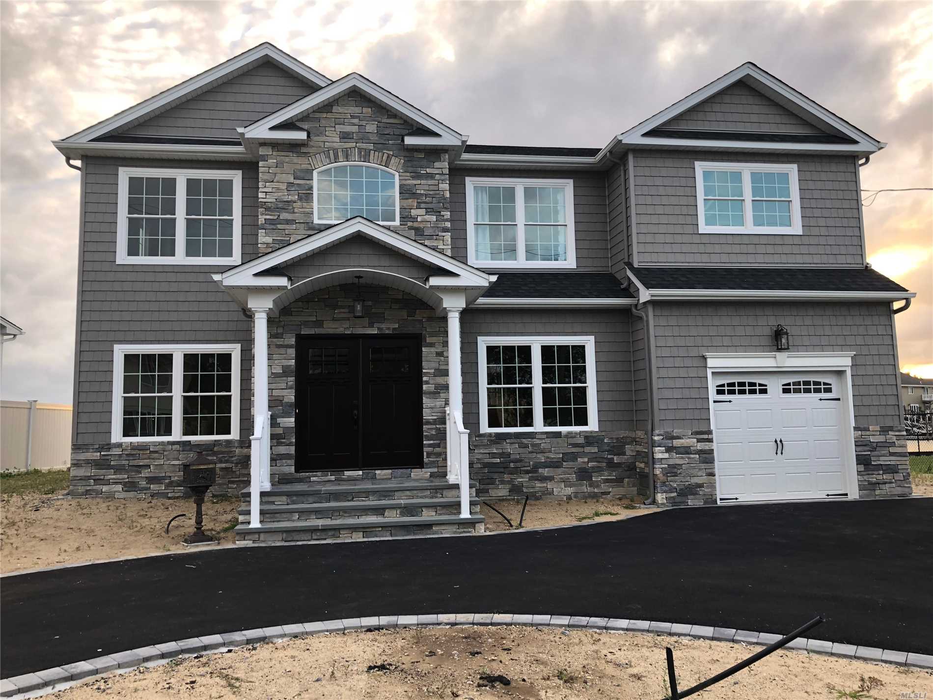 Brand-New Custom *Waterfront* Center-Hall Colonial Being Built In The 1st-Class Massapequa Shores Neighborhood & On Pristine Block Filled W/ Nice Homes! Built By Builder Of 30+ Yrs/350+ Homes. Home Features: Custom Kitchen & Vanities W/ Ss Prof Appliances, Pella Wdws, Sophisticated Moldings Throughout, 1.5-Car Gar, 1st Flr Bdrm/Office, 3 F-Baths, & Large Master Suite W/ Balcony & 2 Wic's & Fbath+Jacuzzi, +++Much More!