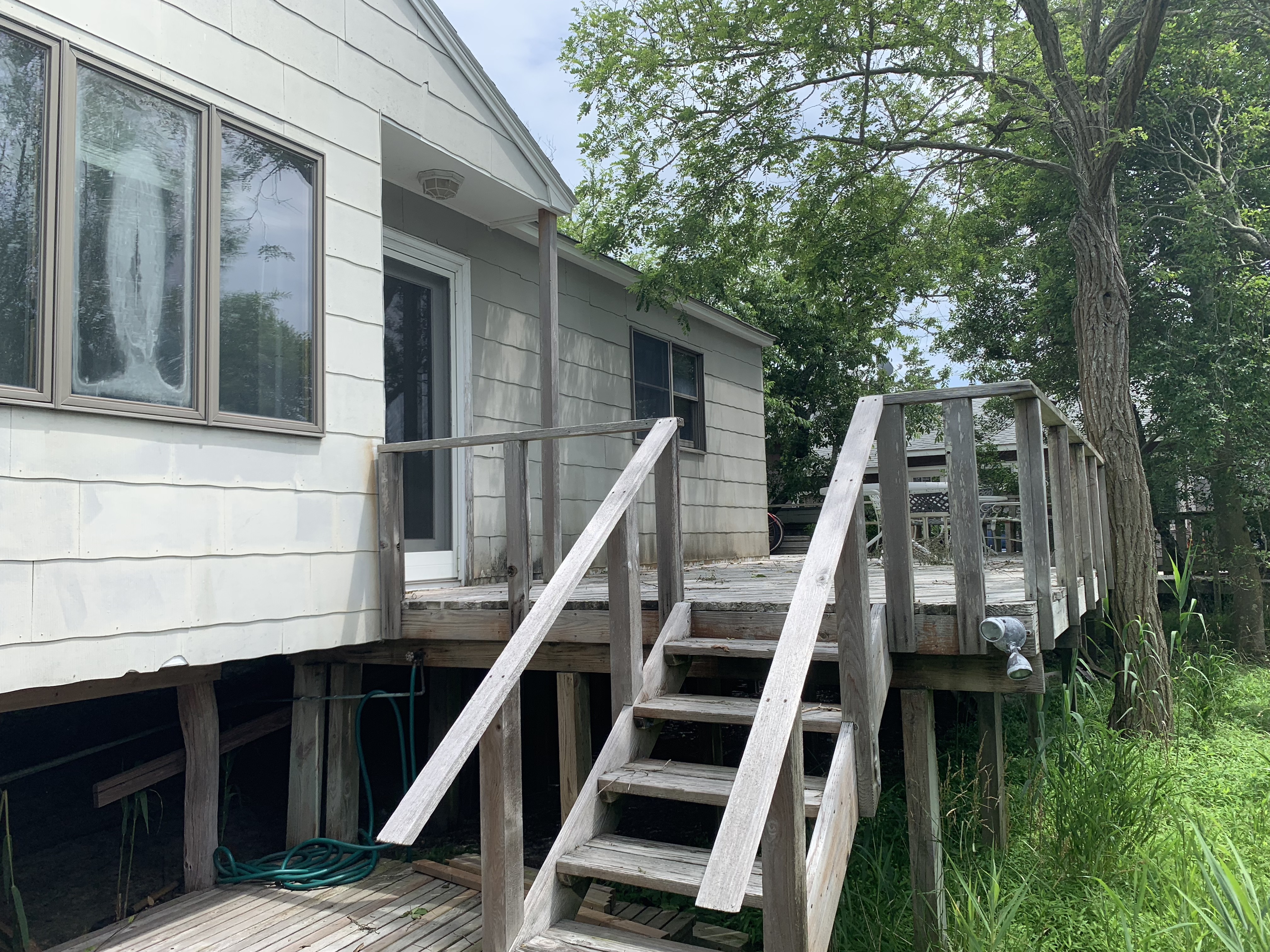 Amazing opportunity!  This charming, elevated 2 bedroom cottage sits on an oversized 75' X 100' lot.  Enjoy this affordable getaway as it is, or expand it to build your dream beach house.  Room for a pool!  Zoning allows for up to 2,625 square foot footprint for a new or expanded structure.  Great location halfway between the beach and town.  
  Updated bath and kitchen with stainless steel appliances.Endless possibilities!  Only 2 minutes to the beach! Low flood insurance, only $803/year!