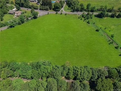 Looking approximately north, this large, cleared property as seen here (presently mowed for hay) is bordered by Duck Farm Road on left, Old Chester Road in the distance, the Heritage Trail corridor in the foreground, and is just left of the Otterkill seen on the right.