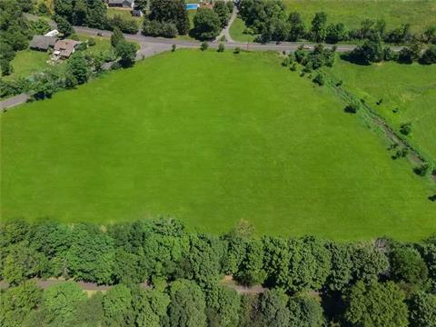 Looking approximately north, this large, cleared property as seen here (presently mowed for hay) is bordered by Duck Farm Road on left, Old Chester Road in the distance, the Heritage Trail corridor in the foreground, and is just left of the Otterkill seen on the right.