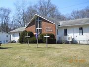 NOTE THE PRESENCE OF RECORDING EQUIPMENT  This property consists of a 3048 sq. ft. Church building with a 3048 sq.ft. basement that has full windows due to being partially out of the ground.  There are new through the wall heat / a/c units installed on both levels.( 7 units upstairs / 3 units in the lower level ) 400 amp service has been installed to support the new units. The basement needs substantial work to be useful. The 1344 sq.ft. house has baseboard heat. The furnace and the oil tank have been removed. Some copper piping has been removed from the basement area. The upstairs portion needs updating. The residential zone that the property is in allows RELIGIOUS FACILITIES, FAMILY DAY CARE AND NURSERY SCHOOL FACILITIES subject to stated items to be complied with.