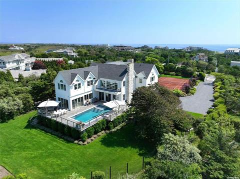 Additional living overlooking the tennis court with spacious deck