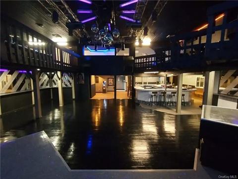 VIEW FROM STAGE TOWARDS FRONT DOOR AND BAR AREA