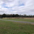 Unique, one of the last, large waterfront lots in Center Moriches, 13 acres, south of Montauk Highway, connected to a .33 acre residential lot off Jarvis included in sale.c.1880 converted boarding house with 3 rental units each with BR Bath Kit/LR on corner of property.Across the creek is county land.Beautiful private views.The 13 acres back onto approx 975 ft of fresh water fed creek, (part of it has evidence of old bulk head), agricultural irrigation well/system, corn crib, 550 gal oil tank, new boiler, new 2 sets/2pools each/8ft ring/cesspools, partial basement, crawl space, enclosed porch, 7yr roof, HW floors.Access via 2 roads and one paperroad.Horse property.House, sheds and barn on survey.The property is set up for agricultural and residential and possible to subdivided with proper permits.Taxes with AG Land exemption $14, 879.(Sold with .33 acre on Jarvis.)
