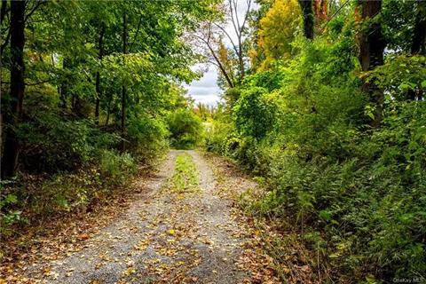 Gravel road leading from Crusher Rd into the property, along the western perimeter.