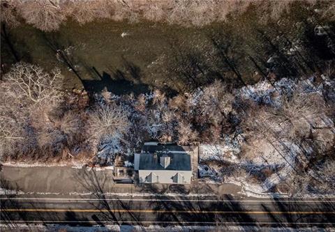 Overlooking a bend in the scenic Ten Mile River. Additional income with 3 rentals upstairs, two 1-bedroom apartments and one 2-bedroom apartment, currently rented month to month.