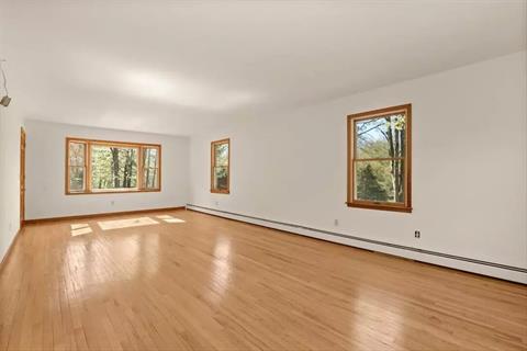 Living Room with lots of natural lighting, hardwood flooring.