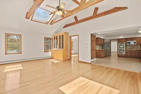 Renovated Kitchen with New Stainless Steel appliances and granite countertops. Breakfast area with Glass doors out to deck.