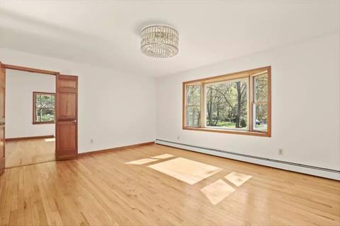 Great Family Room with custom built in cabinetry and glass doors out to deck