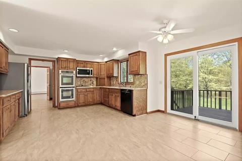 So much counter space for great gatherings. Kitchen communicates well with outside. New appliances, recess lighting , stainless steel sink with a window above. Wood cabinetry with granite countertops.