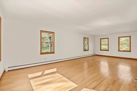 Sun-filled Formal Dining Room with hardwood flooring, and doors to Kitchen and Family Room.