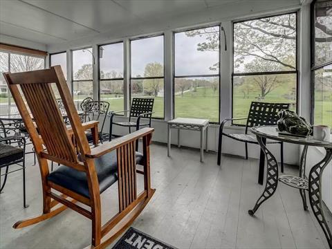 Spacious formal dining room with door to side porch. Hardwood floors underneath carpet, as in most of the downstairs rooms.