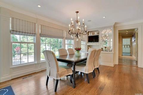 Breakfast room w. custom cabinetry and TV