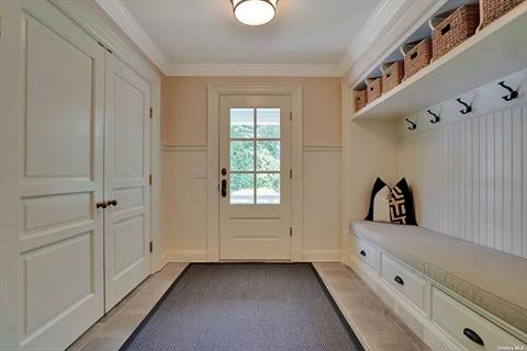 Spacious mud room w. built-in cabinetry and bead board accent moldings