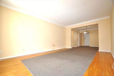 Large Living Room with hardwood floors opens to to the dining foyer.