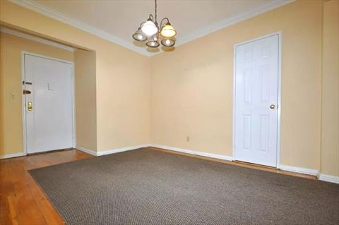 Dining foyer opens to the sunny living room has a closet and hardwood. floors