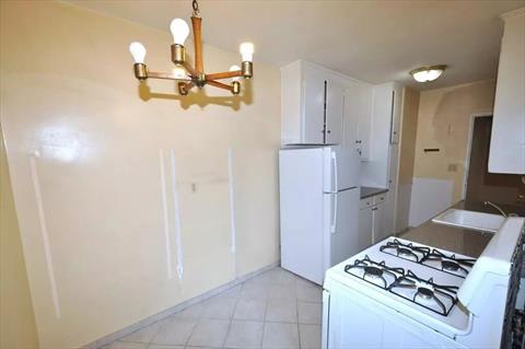 Dining foyer opens to the sunny living room has a closet and hardwood. floors