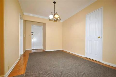 Dining foyer opens to the sunny living room has a closet and hardwood.