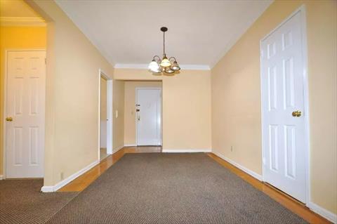 Dining foyer opens to the sunny living room has a closet and hardwood.