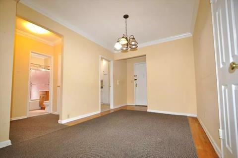 Dining foyer opens to the sunny living room has a closet and hardwood.