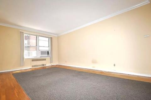 Large Living Room with hardwood floors opens to to the dining foyer.