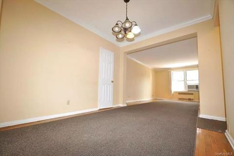 Dining foyer opens to the sunny living room has a closet and hardwood.