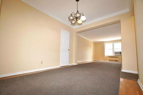 Dining foyer opens to the sunny living room has a closet and hardwood.