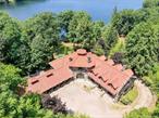 Lorillard Lake House constructed of monolithic stone for the founder of Tuxedo Park in 1893, is considered one of the finest examples of this style of architecture in America. Originally designed by architect James Brown Lord and remodeled in 1905 by Warren and Wetmore(Grand Central Station). The +/- 8.1 acre lakefront estate has a winding private road leading to a graceful courtyard. Main level features newly renovated entrance way with radiant flooring, grand oval living room with 24&rsquo; ceilings, stunning dining room overlooking Tuxedo Lake, elegant library, eat in kitchen, office, two bedrooms, powder room and two fireplaces plus attached garage. Second floor includes three ample bedrooms plus third level massive great room. Lower level houses gym, huge laundry and vast storage/wine rooms. Exquisite landscaping plus stone outbuilding, terraces, floating dock, barn, carriage trails, and long lake shore line. All within 40 miles of New York City Equal Housing Opportunity