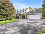 Nestled between the sweet magnolia trees, down a long private road, you will discover a beautiful colonial home with a large welcoming porch. Nearby is the East Landing Peconic Bay private beach, this pool home is surrounded by lush mature landscaping, perfectly centered on 3/4 acre. This sundrenched home has a large open living room which flows into an circular dining room with large windows overlooking the large enteratining deck and backyard provillian. Island kitchen centrally located which opens up to a family room. The first floor has a wood burning fireplace in living room and in the family room. A separate laundry room leads to a 2 car garage. Upstairs the primary suite has a large walk-in closet, soaking tub with separate shower area. There are 3 other bedrooms, one is en-suite. The walkout basement has 3 separate entrances, an extra full bath and a summer kitchen den/guest suite. Many extras with this home.