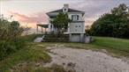 Nature Lovers Paradise! A Haven for Busy Business People and Creatives Alike. Designed with spaces oriented toward the ocean and sky, the house is an extension of the nature surrounding it. This truly unique property is just shy of 4 acres, on the water, with its very own private beach. This hidden gem is nestled in the tranquil embrace of Center Moriches, along the idyllic shores of Long Island&rsquo;s East End. The Center Moriches location allows you to enjoy the best of both worlds - proximity to New York City, and the allure of nature- beaches, parks, and recreational opportunities at your fingertips. There is a private community Holiday Beach with Boat slips available. You also have all of the pilings in place for your very own private 60 foot dock. Welcome to a residence where time honored elegance intertwines with the splendor of nature. This is more than a Home; it&rsquo;s a sanctuary of luxury, a canvas for creating cherished memories, and a symbol of the extraordinary. A haven for bringing together family and friends, with west-facing exposure, you&rsquo;ll relish the privilege of sunset views that paint the sky. This sprawling 6200 square-foot house has four private en-suite bedrooms, an additional three guest bedrooms, four full bathrooms and 1/2 bath, catherdral ceilings, dine in kitchen, home-office, guest quarters, two first floor bedroom suites, second level primary suite and a large second level guest suite. The heart of the home unfolds into an open floor plan layout, seamlessly connecting the large eat in dining, and kitchen areas. This inviting expanse is a symphony of light and space, with French doors and floor-to-ceiling windows, that frame captivating vistas and infuse the interiors with an abundance of natural light, giving the space a feeling of open, airy grandeur. Just steps away, the gentle ebb and flow of the shore provides a mesmerizing backdrop. Watch the sunrise from your private beach and follow the moon rising over the horizon. As you ascend to the upper level, you will find the primary suite, which is a haven of opulence, offering sweeping panoramic views that extend to a private deck. The en-suite bathroom, boasts Terrazzo floors, a deep floating tub and a walk-in dressing room. The journey continues with a guest bedroom off the master suite, and another large guest bedroom found at the far upper level with an en suite bathroom adorned with a claw foot tub and a private deck. The center room between both suites is crowned by a balcony overlooking the living room and breathtaking water views. Beyond the elegant interiors, the outdoor spaces beckon you to embrace the beauty of nature. An oversized gunite heated natural pool, is seamlessly integrated into the expansive deck, which includes a separate jacuzzi for six, inviting you to experience the joys of outdoor living. Just in front of you lies your private beach, and the pristine Moriches Bay, with a large lawn and forested area behind, bestowing the gift of natural privacy to be cherish. A popular summertime destination for the residence of Center Moriches is Great Gun Beach located on the fire, Island seashore just off of Smith Point State, Park Preserve. You can go by boat across the intercoastal waterway to enjoy a picnic, walk along the sand dunes, or swim in the Atlantic ocean! There is a magical waterfront restaurant around the block called Silly Lilly&rsquo;s which offers everyone the opportunity to rent a boat and enjoy waterfront dining. This property is truly unique and one of a kind. When you drive up the long winding private entrance you instantly feel like you are on vacation. The homeowner also owns an additional parcel of land adjacent to the property available for sale.