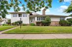 This split-level home commands attention on an expansive 80x100 corner lot and just one block from the beach. The living and dining area is impressively vast and adorned by panoramic bay windows that saturate the space with natural light. The kitchen boasts a top-tier Wolf stove, Sub-Zero fridge, and exquisite granite countertops. Adjacent to the kitchen, is a private family room that offers a tranquil retreat. With five well sized bedrooms, including a master bedroom with wall-to-wall closets, the home ensures both comfort and ample living space. The split-level basement serves as a versatile area with two additional bedrooms, a full bath, and generous room for guests, a nanny, or in-laws. Throughout the home, hardwood floors add an element of warmth and sophistication. Never worry about Neponsit street parking restrictions again!!! The 4 car driveway leads right into an oversized two-car garage.