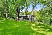 Welcome to your picturesque and dream rental, with breathtaking falling waters overlooking the rushing Mill River and one of the Twin Ponds. Water views and stunning interior design come together to create an unforgettable getaway experience. Contemporary home designed by noted architect Vuko Tashkovich who worked for the architects Eliot Noyes, John M. Johansen and I. M. Pei & Partners then remodeled by the noted architect Levy. This gorgeous property boasts floor-to-ceiling windows that offer dramatic panoramic views of the surrounding landscape, providing an immersive and relaxing atmosphere for all guests. Inside, this modern house boasts a spacious and open floor plan which furnished stylishly by linge Roset, Cappellini and Minotti. The kitchen is fully equipped with all the necessary appliances and tools to prepare gourmet meals, and the living room offers an ideal space to relax. The private Master Suite has a walk-in Dressing Room. Opulent Master Bath has luxurious radiant heat. Three additional Bedrooms including private Guest Bedroom. The home has every amenity including elevator and automatic generator. Covered Dining Terrace overlooking the heated salt-water pool. There is a pool house with a bathroom and outdoor shower. Step outside and enjoy the great outdoor space with a large pool and Jacuzzi perfect for lounging in the sun or taking a refreshing dip. With ample outdoor seating areas, you can enjoy al fresco dining or simply take in the stunning scenery as you unwind with your loved ones. Lake has a dock- perfect for kayaking, fishing, etc. Over three landscaped acres with specimen trees and flowering. The outdoors have mature specimen plantings including Japanese Maples and Weeping Beech. Located in a cul de sac the home is a sanctuary of privacy in the heart of Pound Ridge, minutes to the charming town of Pound Ridge, Scotts Corners, with farmers markets and an array of eclectic shops, a European fine bakery and restaurants. Whether you&rsquo;re looking to hike, bike, or simply relax and soak up the stunning river and lake views, this modern house is the perfect place to call home. Book now and start creating unforgettable memories that will last a lifetime.