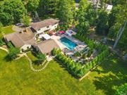This unique residence on 2 acres in the Village of Upper Brookville, within Locust Valley School District, features a large guest wing bedroom and den suite on the 1st floor plus the primary bedroom and two bedrooms on the 2nd floor. A gated entrance leads to a courtyard and flat land. In-ground heated saltwater pool, waterfall, expansive stone patio, pool cabana and outdoor bar are phenomenal places to enjoy the scenic property. A fully equipped movie theatre, Poker Room and Wet Bar has a separate entrance. 2 car attached garage. Natural gas heat has been piped in, rare for the area. Interior layout allows for a variety of ways in which to enjoy the spaces. A formal dining room is off the gourmet kitchen plus an adjacent stone lounge featuring hand built pizza oven. The welcoming front porch enters into a two-story foyer and spacious den. This property is located on a dead end street north of 25A. Nearby the Planting Fields Arboretum State Park and both the towns of Locust Valley and Oyster Bay. Enjoy North Shore living within proximity to numerous golf clubs and tennis clubs, nature preserves, bicycle trails, working farms and cultural destinations. This is a beautiful country setting not far from Manhattan and the perfect place to enjoy immediately.
