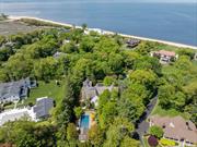 This custom built Hampton-style colonial unfolds on over 2 acres of sprawling manicured grounds in the prestigious Village of Sands Point. The property boasts an in-ground swimming pool, a cabana with wet-bar, outdoor kitchen and a spacious full bathroom. The 7, 700+ square foot home boasts 6 bedrooms, 8 bathrooms, high ceilings throughout, top-of-the-line appliances and an abundance of natural light. The custom wood flooring, fully stocked wet-bar, circular breakfast nook surrounded by windows and the oversized family room with a spectacular barreled ceiling drive home the architectural integrity & hand craftsmanship that went into constructing this one-of-a-kind residence.