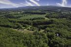 The options are endless for this very special 120-acre property on a spectacular country road in beautiful Ancramdale, NY. The property, which has been a family compound for multiple generations, begins with a very long private driveway that leads to the original 1850&rsquo;s farmhouse and guest cottage overlooking a gorgeous 4+ acre pond. As you continue down the driveway, past lovely rolling hills, an old swimming pool & tennis court, a summer cottage and a couple of other outbuildings, the property goes up a hill to two additional residences built in 1970 and 2000, with stunning views of the mountains and exquisite surrounding farmland. This fabulous property is waiting for new owners to make a new family compound. With the exception of the house built in 2000, the others all need to be torn down or completely re-built (all the infrastructure is in place such as driveway, electric, septics, wells), so it is a question of building, but not putting in infrastructure. Conveniently located to all that the Hudson Valley has to offer, less than 10 minutes to Millerton and Pine Plains, less than 30 minutes to Rhinebeck, Hudson and Millbrook and just 2 hours to Manhattan. Bring your imagination, wonderful properties that offer this level of privacy and views extremely rare., Other School:DUTCHESS DAY, OTHERROOMS:Office/Computer Room, Library/Study, Great Room, Laundry/Util. Room, Rec/Play Room, Family Room, InteriorFeatures:Electric Dryer Connection, Walk-In Closets, Sliding Glass Doors, Gas Stove Connection, Basement:Interior Access, Garage Access, FLOORING:Wood, Ceramic Tile, AboveGrade:4144, ROOF:Metal, EQUIPMENT:Carbon Monoxide Detector, Smoke Detectors, Cooling:Ceiling Fan, Below Grnd Sq Feet:300, FOUNDATION:Concrete