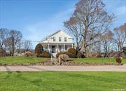 On the corner of Main Road and Tuthills Lane, in the charming Hamlet of Jamesport, the beautiful historic Greek Revival Daniel Tuthill homestead sits high on the hill. Included on this enchanting 1.35-acre property is a picturesque English-style historic barn, a classic semi-underground potato storage barn, and an early 20th-century outbuilding, all situated in the coveted Rural Corridor zoning with high visibility road frontage for your business. This property can be used for agricultural production, a farmstand, wine tasting room, retail stores, residential housing, and so much more! It is currently leased to a local business.