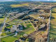 On the Main Road, in the charming Hamlet of Jamesport, is 55+ acres of Suffolk County preserved organic farmland with prime Long Island soils. Currently home to a certified organic vegetable, fruit, and flower farm, as well as an enchanting hardwood forest, this DRS farm is set up with two deep fully operational wells; an open-air storage barn; refrigerated cold storage; greenhouses; distributed underground irrigation, underground electricity, and 8-ft. deer fencing - all across 20 acres. This farm sits in the coveted Rural Corridor zoning with high visibility road frontage for your business.