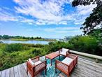 Looking for both waterfront and a unique home. Welcome to Quaint in Quogue, located in a premier private bayfront community, this 3 story lighthouse style home with detached double garage was built in 1957 and has breathtaking views of Shinnecock Bay plus the peace and quiet you need to unwind. The main floor offers a bedroom, an office area, living room with fireplace, living area with sweeping views of the bay, kitchen, full bath, stackable washer and dryer & large family room with pull-out sofa bed. The second floor offers the main suite with the most stunning views, walk in closet and full bath. The third level is the charm! A most spectacular finished space surrounded by windows boasting stunning views past Ponquogue bridge. Step outside on the wrap-around deck and enjoy the cool breeze and views. This unique property also offers a lower level deck to enjoy early morning coffee or late afternoon BBQs and just a short 2 minute stroll to the beautiful Private beach. There are approved plans to upgrade the existing property. The large double garage allows for the possibilities to convert to additional living space with planning approval required.