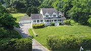 Panoramic forever water views of Mattituck inlet, and Long Island sound. Easy walk to the beach, for a dip in the water. This custom home has 5 bedrooms, 4.5 baths, Den, office, Garage galore with 5 garages, 2 attached, 3 detached. Tennis court, with 1.6 acres, near beach and boating.