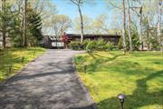 From high atop a hill, this beautiful home has a must-see panoramic view over Little Fresh Pond. This jewel of a home is perched on top of .83 acres, with east and west exposures, a water view, and stunning sunsets. With 2-bedrooms & 2 full spa baths this contemporary home has 12 foot ceilings, skylights, lots of windows allowing sun to stream all day. A high end newly renovated Eat in Kitchen has state of the art appliances, new windows, new porcelain flooring throughout, quartz countertops and a large island and pantry. The living room has a wood burning fireplace featuring polished concrete marble and new luxury vinyl flooring throughout. The spacious open concept layout leads to a newly renovated large deck from both the living room and dining room. It is the perfect spot for entertaining family and friends. Enjoy kayaking and canoeing on the pond from your private back deck. There is room for a pool and all wetland setbacks as required by Southampton have been approved. Other features include central air, ADT security system, in ground irrigation, invisible electronic deer fencing and satellite TV. The peace and quiet of 246 Little Fresh Pond are close to beaches, shopping, Southampton Village, fabulous restaurants and close to neighboring towns.