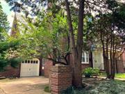 This English Garden Home is constructed of brick with a slate roof. There are 9 rooms on 3 floors totaling about 2, 500 square feet, plus a basement. Its huge rear yard is unimpeded by a driveway! You enter the vestibule, then through a French door, to the massive living room with a fireplace. Beyond is the spacious formal dining room with a French door that leads out to the rear yard. To the left is the kitchen, also with a door out to the yard. Then up a few steps is the sunroom, that sits atop the attached garage. This 9&rsquo; by 21&rsquo; space is enclosed by three sets of French doors as well as three windows facing back and one facing front. A few more steps up take you to the 2nd floor, with 2 huge bedrooms. The one facing the rear has its own renovated bath. The front bedroom, of equal size, faces west and has its own entrance to the hall bathroom. Another flight up to the third floor. In front are 2 more modest bedrooms, each with a dormered window facing west.  Facing the rear is a large bedroom fully paneled in handsome knotty pine, that steps down to another roughly 9&rsquo; by 9&rsquo; space with its own window. The main room has two east-facing windows and built-ins for books and storage. There is a large full bath that retains its original 1920s details. You also have a large basement and room to park a 2nd car in front of the garage.