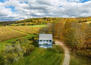 Hudson Valley private hillside retreat with south western mountain views. Located in the desirable Shekomeko Valley this fully furnished country oasis home is on over 30 bucolic acres. Set well off the beautiful country road, the driveway leads to this renovated private haven. Gorgeous vistas of countryside farms and mountains, the landscaping allows for relaxing exploration and exercise through walking paths, pastoral fields and glorious natural vegetation. Exterior wide decking provide additional vantage points for the spectacular surroundings. Entering the house you will see thoughtful stylish design bathed in bright natural light. There are wide-board pine and hardwood maple floors. The Great Room includes vaulted and beamed ceiling living and dining spaces, featuring a wood-burning fireplace. The galley kitchen is open and cheerful with up to date appliances. Glass door with wooden screen door takes you out to one of the decks from here. All bathrooms are fully renovated with accent lighting. Also on this level is the Primary bedroom which includes a wonderful wall of windows and cathedral beamed ceiling. A loft up top brings an additional bedroom with vaulted ceiling. The lower entry level provides new charming screen door, the foyer and additional bedroom with glass slider and another full size bathroom. An exercise room and one car garage is also accessed here. Also included is the use of a custom gym nearby with self guided mirror trainer program. Yoga teacher, Personal Chef and Physical Therapy also upon request. Nearby towns of Pine Plains, Millbrook, Rhinebeck, Millerton and Sharon CT. all provide excellent dining and shopping. This is all just two hours from New York. Train service provided by Metro North or Amtrak. Experience the Hudson Valley!