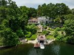 Welcome home to this Beautiful Adirondack styled retreat, with stunning panoramic views of Lake Mahopac, just one hour to NYC. Live your best life in this lakefront home with almost 190 feet of your own shoreline. This lovely 4500sqft, three level home includes incredible lakefront amenities - Boathouse, Cantilevered dock, Jet-ski lift, Firepit, Inground pool, Hot tub, Italian style outdoor kitchen with fireplace, Waterfall, Decks, Porches and so much more. Enjoy all of these special features, which are beautifully positioned with breathtaking views of the lake. The perfect blend of luxury, comfort and natural beauty! The home also has a naturally bright and sunny open floor plan which allows for stunning lakefront views. Entertain from your chef&rsquo;s kitchen that easily sets the stage for a progressive dinner party from the multiple entertaining spaces. Both indoors and outdoors provide wonderful experiences for unforgettable memories for every generation of family and friends. With an abundance of well-placed mature trees, stone walls and perennials, this property feels very private, like a dream come true! There are two separate garages, in addition to spacious parking options. Lake Mahopac is a 583-acre motorboat lake, close to golf, lakefront dining, shopping and nearby train station - Croton Falls. Easy access to the Taconic State Parkway and for all that the Hudson Valley has to offer!