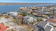 Exceptional Waterfront Residence on Bay Boulevard, Atlantic Beach - the Most Coveted Location on the South Shore. Immaculate and spacious, this five-level home nestled on a serene tree-lined street boasts a private dock. Revel in the grand entrance foyer, a fireplace-adorned living room, formal dining, and a chef&rsquo;s kitchen. The den, with French doors leading to an in-ground heated pool amid a botanical garden, adds allure. A master bedroom duplex suite commands its own level, while three additional bedrooms and two baths grace another. The lower level features a two-room office and guest bathroom, ideal for extra bedrooms. Enjoy a fully finished basement with a gym and full bath. No need for expansions - this home has it all! Bulkhead updated three years ago, a new roof on the main level, and ready for immediate occupancy. Stroll to the residents-only beach and beach club with full membership. A short walk to houses of worship and just 23 miles to NYC. Tranquil surroundings and attractively priced for a swift sale.