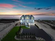 Transcending the notion of a mere home with an exquisite blend of timeless design and contemporary elegance, this newly constructed Nordic Modern Beach Home by First Dunes stands as a testament to coastal luxury living, offering a lifestyle of serenity and sophistication. Indulge in the breathtaking direct access and views of Moriches Bay from the moment you enter the grand foyer adorned with a bespoke glass-wrapped staircase that ascends like a work of art, setting the tone for the elegance that awaits within. The main level invites seamless indoor-outdoor living, with sweeping bay views serving as the backdrop to the open-concept living and dining areas. A chef&rsquo;s dream kitchen, outfitted with top-of-the-line Gaggenau and Thermador appliances, beckons culinary creativity, while the adjacent living room features a porcelain-wrapped fireplace and expansive sliding doors leading to your private outdoor sanctuary. Relish in the tranquility of the master suite on the second level, complete with vaulted ceilings, a private balcony, and a spa-like ensuite boasting ocean views. Two additional bedrooms on this level offer their own luxurious retreats, each with ensuite bathrooms and privacy. The third level offers two additional bedrooms with ensuite bathrooms and a bonus room, providing ample space for guests and leisurely pursuits. Every facet of this exceptional residence exudes craftsmanship and refinement with an array of coastal details ensuring the highest standards of resilience, durability and safety. The beautifully landscaped grounds lead to a four-car garage and additional storage underneath the home, offering practicality without compromising on aesthetics. Elevate your lifestyle to new heights as you embrace the coastal essence you&rsquo;ve always desired. For those with a passion for waterfront living, this property grants deeded ocean access unlocking a world of relaxation and water sports and direct access to Moriches Bay for fishing, clamming, swimming and boating including space for a mooring. In a locale where new construction opportunities are rare to come by, this home stands as a testament to unparalleled craftsmanship and coveted coastal living catering to the discerning buyer.