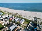 Unique opportunity for 2 adjacent lots on the beach, Build a family compound directly on the oceanEnjoy the fresh salt air in this magnificent home right on the oceanfront. Amazing views of the Atlantic abound from private decks on all 3 levels, including one right off the primary suite, one on the main level and one right on beach level. The primary suite features a fireplace and a brand new bathroom with radiant heat flooring, and there are 4 additional spacious bedrooms with space to add a sixth. An expansive open-plan living/dining room is full of natural sunlight, and also has a fireplace. The updated kitchen boasts quartz counters and stainless steel appliances with modern cabinetry. A large 53 x 100 buildable lot is attached to the property. Located in the trendy west end, steps away from the beach and the best restaurants and shops in Long Beach.