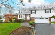 Beautiful and bright, expanded 4 bedroom Split-level home in the coveted Woodbury Hills! The entryway leads to a stunning spacious living area with new bay window, dining room with view of the expansive yard and open kitchen with island and 3 year old appliances & gas cooking. An oversized primary bedroom with en-suite bath and two large walk-in closets complete the main level. The 2nd level boasts 3 well-appointed bedrooms with an updated full bath. The lower level is complete with a spacious den, half bath and huge play/excercise room - great for kids, guests or work from home space. The house sits on a quarter acre of land with meticulously landscaped, fenced yard, on a dead end street for extra play space! With gas heat, central air, IGS, alarm & new flooring- this house has it all & will not last!